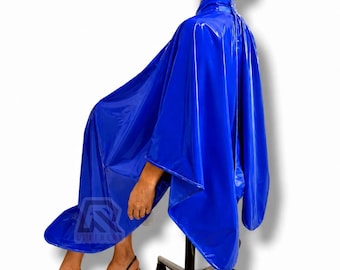 May include: A glossy, vibrant blue salon cape with a high collar and a snap closure at the neck. The cape features a smooth, reflective surface and a logo with the text "R LEATHERS" printed in the lower left corner of the fabric.