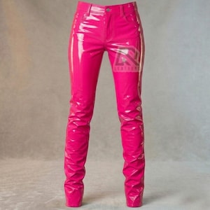 May include: Bright pink, high-waisted pants with a glossy, patent leather-like finish. The pants have a classic five-pocket design and a button closure. The text "LEATHER" is visible on the right leg. The pants are designed to be form-fitting.