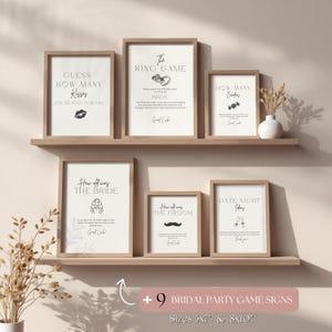 May include: A collection of framed bridal party game signs in various sizes. The signs feature black text on a white background with simple illustrations. Games include "Guess How Many Kisses" and "The Ring Game."
