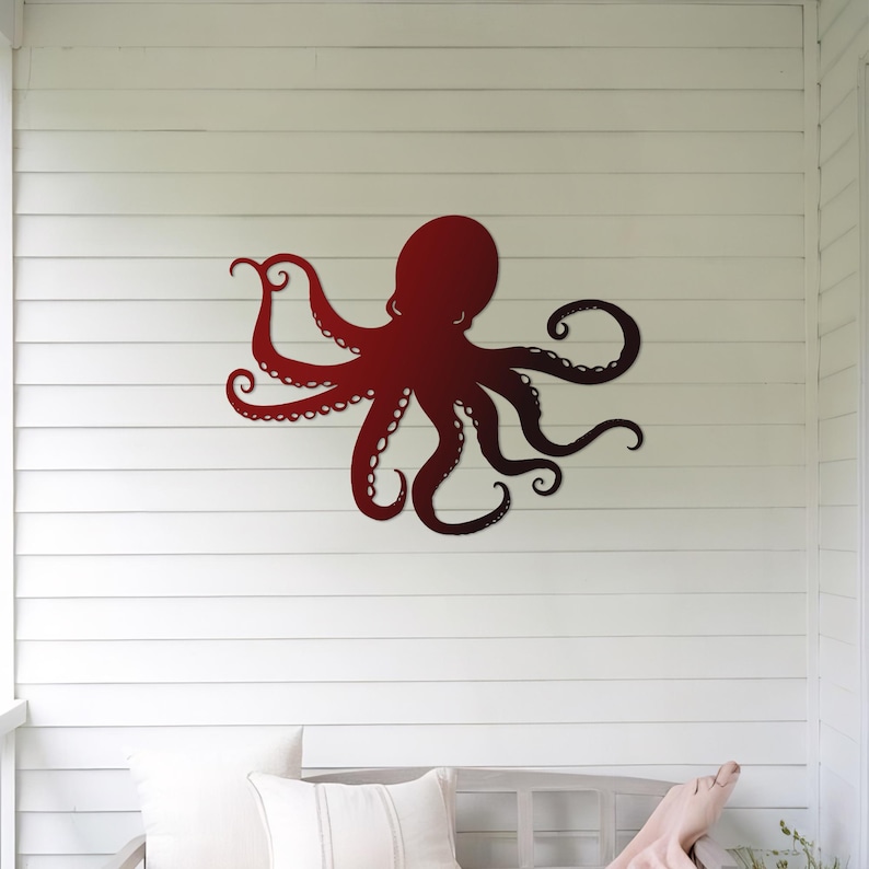 May include: A red metal octopus wall decor with a gradient of color from dark red to light red. The octopus is mounted on a white wall with white horizontal siding.