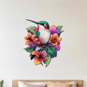 May include: A green and white hummingbird perched on a branch with orange and purple flowers. The hummingbird is surrounded by green leaves.