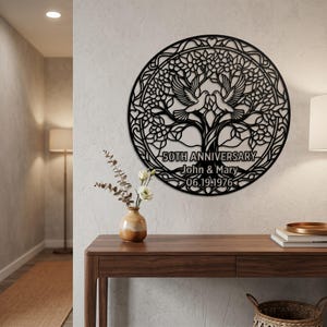 May include: A circular black metal wall art piece featuring a tree with two doves perched in the branches. The design includes the text 50TH ANNIVERSARY, John & Mary, and 06.19.1976. The intricate cutout pattern is framed by a circular border with hearts.