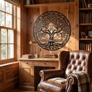 May include: A circular black metal wall art piece featuring an intricate tree of life design with two doves at the top. The text "50TH ANNIVERSARY", "John & Mary", and "06.19.1976" is engraved into the center of the metal structure.