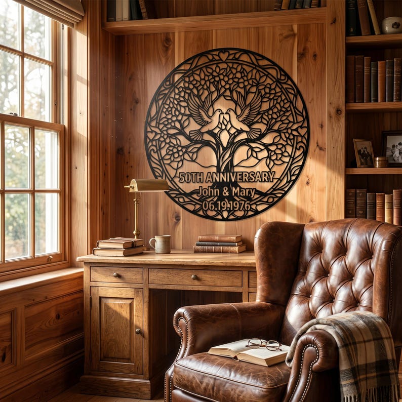 May include: A circular black metal wall art piece featuring an intricate tree of life design with two doves at the top. The text "50TH ANNIVERSARY", "John & Mary", and "06.19.1976" is engraved into the center of the metal structure.