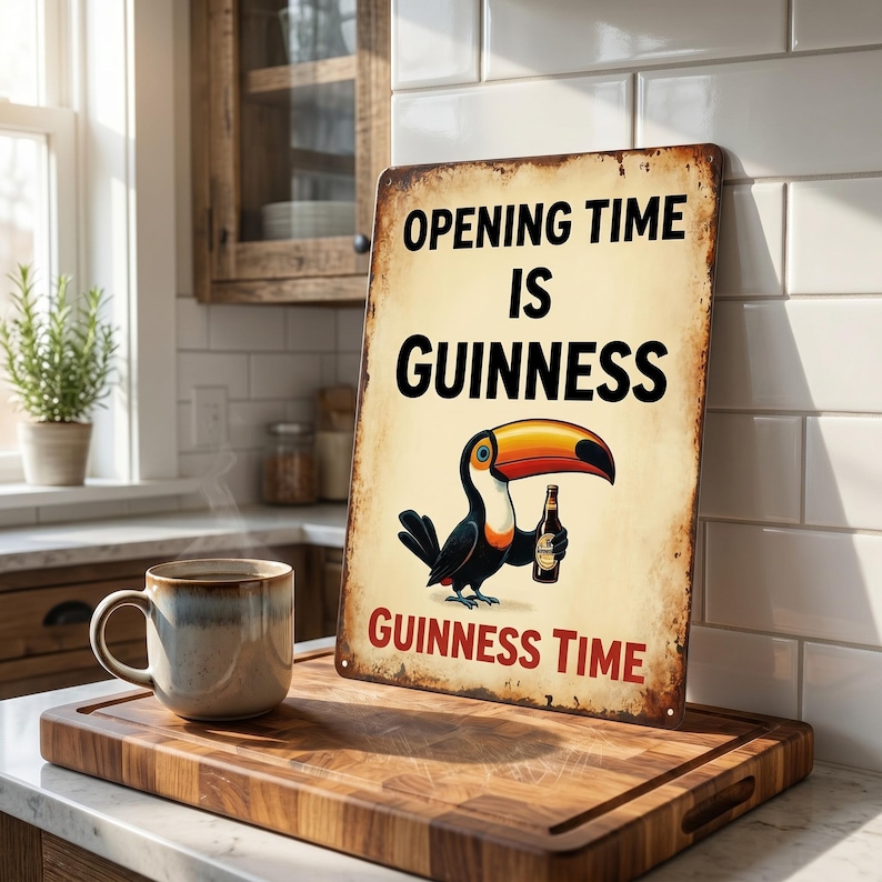 May include: A vintage-style metal sign with the text "OPENING TIME IS GUINNESS" and "GUINNESS TIME". The sign features a cartoon toucan holding a bottle of Guinness. A mug of coffee sits on a wooden cutting board.
