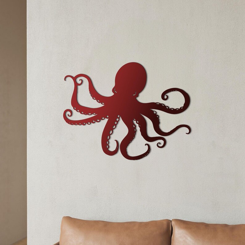 May include: A red metal octopus wall decor with eight tentacles. The octopus is in a silhouette style and is mounted on a white wall.