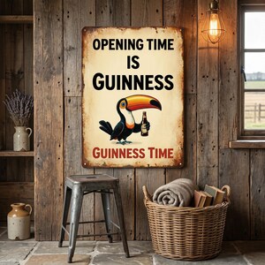 May include: A vintage-style metal sign with the text "OPENING TIME IS GUINNESS" and "GUINNESS TIME". The sign features a cartoon toucan holding a bottle of Guinness. The sign is mounted on a rustic wooden wall.