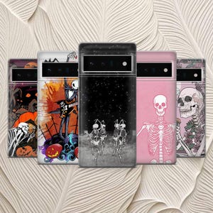 May include: A collection of phone cases with Halloween-themed designs. The cases feature images of skeletons, pumpkins, and other spooky elements in various colors. The cases are displayed against a textured, off-white background.