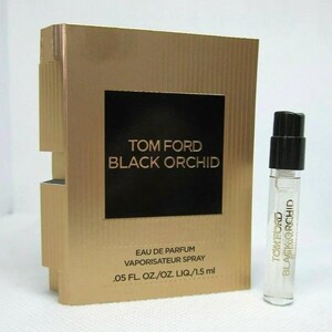 May include: A gold-colored box and a small clear perfume vial. The box has a black square with the text "TOM FORD BLACK ORCHID". The vial has a black cap and the text "TOM FORD BLACK ORCHID". The box also says "EAU DE PARFUM VAPORISATEUR SPRAY .05 FL. OZ./OZ. LIQ./1.5 ml".