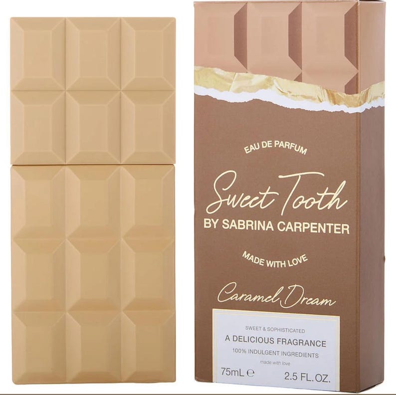 May include: A perfume bottle and box set. The bottle is a light brown, rectangular shape with a textured surface. The box is brown with the words "Sweet Tooth" and "Caramel Dream" printed on it. The bottle contains 75mL or 2.5 FL.OZ.