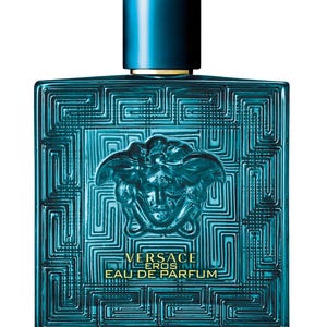 May include: A turquoise Versace Eros Eau de Parfum bottle. The square bottle features a geometric pattern and a Medusa head emblem. The cap is a dark teal color with a gold accent.