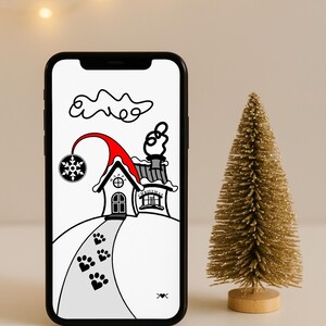 May include: A smartphone shows a festive Christmas scene: a house with a red roof and a snowflake decoration. A small, gold-coloured Christmas tree is to the right. The image is set against a neutral background with soft lighting.