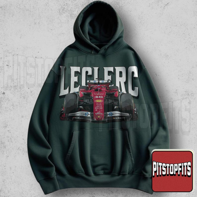 May include: Dark green hoodie featuring a red race car graphic with the number 16. The word "LECLERC" is printed in large white letters above the car. A small logo that says "PITSTOPFITS" is in the bottom right corner.