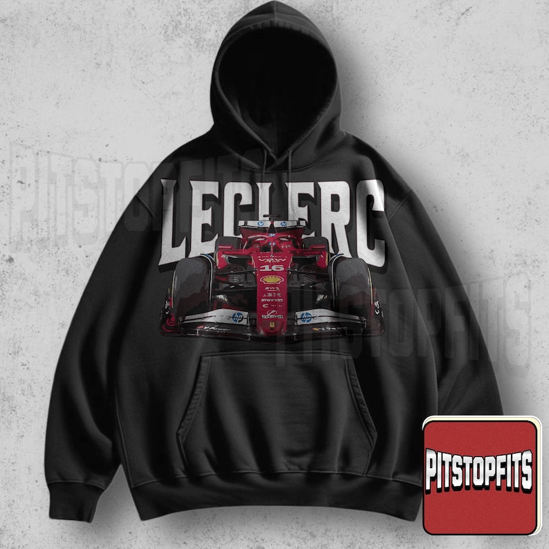 May include: Black hooded sweatshirt featuring a red Formula 1 race car graphic with the name "LECLERC" in large white letters across the top. The sweatshirt has a front pocket and a drawstring hood. The Pitstopfits logo is in the bottom right corner.