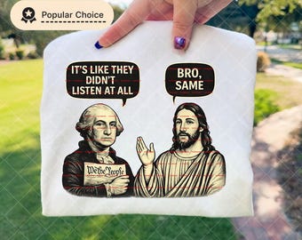 May include: White t-shirt featuring a graphic of George Washington and Jesus with speech bubbles. Washington's bubble says, "It's like they didn't listen at all," and Jesus's says, "Bro, same." The shirt has a "Popular Choice" badge.