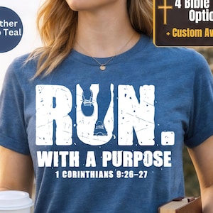 May include: A heather deep teal short-sleeve t-shirt featuring the white distressed text RUN. WITH A PURPOSE and 1 CORINTHIANS 9:26-27. The graphic includes a small white icon of a running shoe integrated into the letter U of the word RUN.