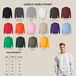 May include: A colour chart for a unisex sweatshirt featuring seventeen solid colour options including black, dark grey heather, athletic grey, white, dark chocolate, maroon, red, orange, light pink, sand, purple, light blue, irish green, forest green, military green, and gold, with a size chart and a white sweatshirt.