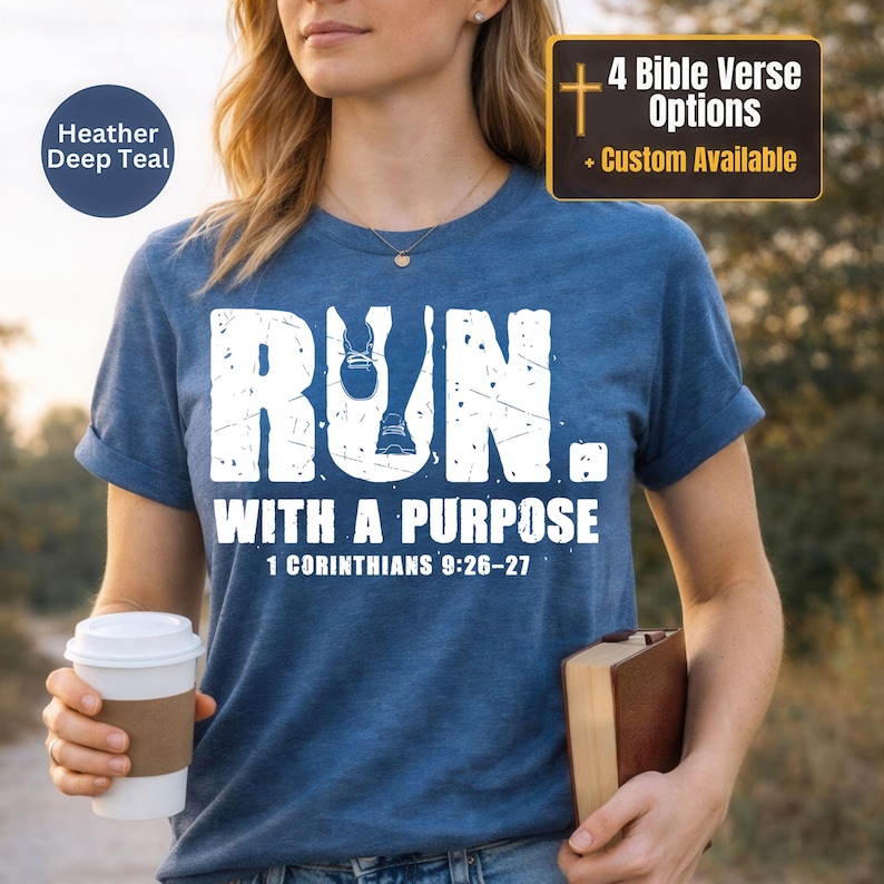 May include: A heather deep teal short-sleeve t-shirt featuring the white distressed text RUN. WITH A PURPOSE and 1 CORINTHIANS 9:26-27. The graphic includes a small white icon of a running shoe integrated into the letter U of the word RUN.