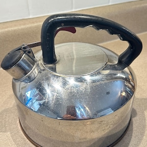 May include: A set of three ceramic mugs with a speckled, matte finish. Each mug features a different color: light blue, cream, and gray. The mugs have a simple, modern design and a comfortable handle.