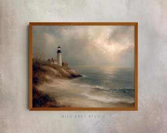 May include: A framed landscape painting of a lighthouse on a cliff overlooking the ocean. The artwork features a white lighthouse with a black top, a small red building, and a sandy beach. The sky is overcast with a soft, diffused light. The frame is made of wood, and the text "MILO GREY STUDIO" is at the bottom.