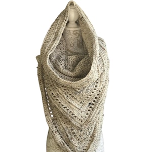 May include: A beige crocheted cowl with a hood. The cowl is made with a textured stitch and has a loose, drapey fit.