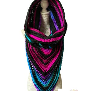 May include: A black, pink, purple, and blue striped crochet cowl with a hood. The cowl is on a white mannequin.