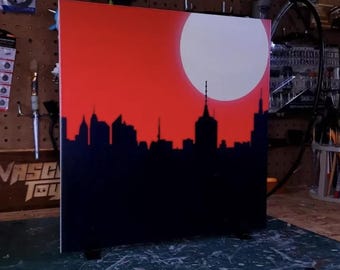Painel de fundo IKEA Detolf "Noite Vermelha" com silhueta do horizonte para exibição de figuras de ação.