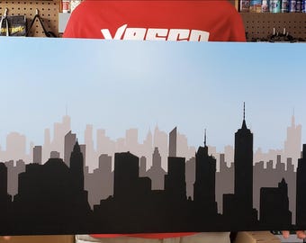 Painel de fundo de 76 cm x 40 cm com silhueta da cidade para exibição de figuras de ação.