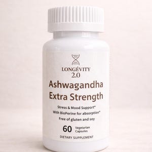 May include: A white bottle of "Ashwagandha Extra Strength" capsules. The label includes the brand name "LONG&Eacute;VITY 2.0" and details about stress and mood support, with 60 vegetarian capsules. The bottle has a white cap.