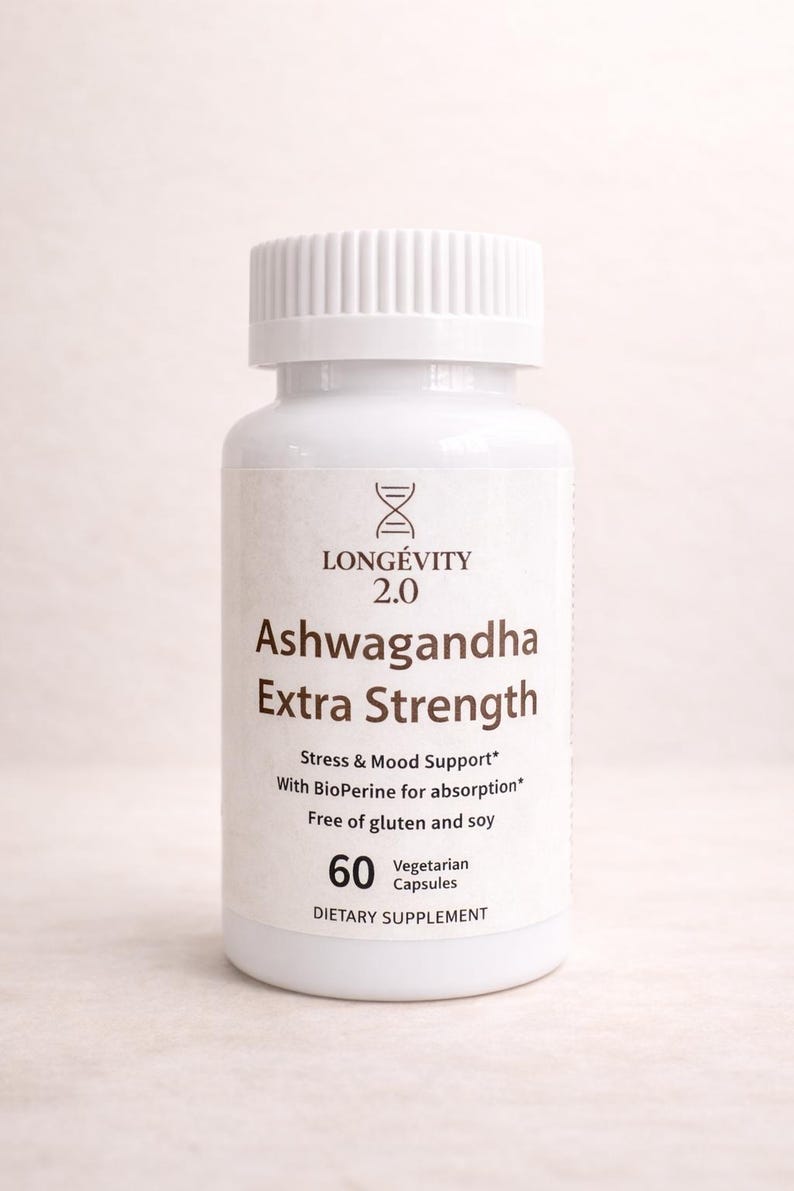 May include: A white bottle of "Ashwagandha Extra Strength" capsules. The label includes the brand name "LONG&Eacute;VITY 2.0" and details about stress and mood support, with 60 vegetarian capsules. The bottle has a white cap.
