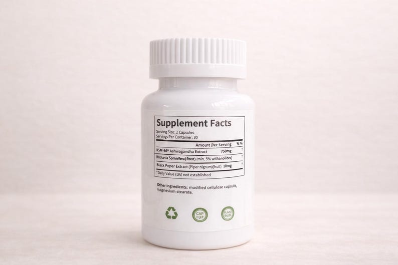 May include: A white supplement bottle with a white cap. The label includes the text "Supplement Facts" and ingredient information, including Ashwagandha Extract and Black Pepper Extract. The bottle has green plant-based symbols.