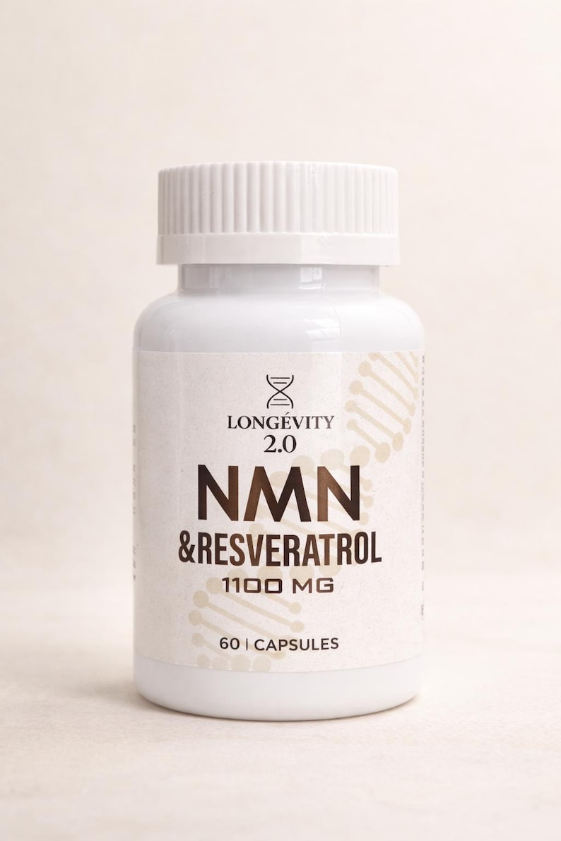 May include: A white bottle of NMN & Resveratrol capsules. The label reads "Longevity 2.0" and "1100 MG". The bottle contains 60 capsules. The bottle has a white cap and a light beige background.