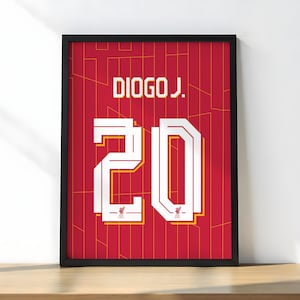 May include: Framed print of a red soccer jersey with the name "DIOGO J." and the number "20" in white. The jersey design includes a subtle pattern and the Liverpool FC logo.