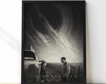 May include: Black and white framed print of the movie Interstellar. The image shows two people standing in a field, with a car and a dramatic sky featuring a celestial body. The word "INTERSTELLAR" is printed at the bottom.