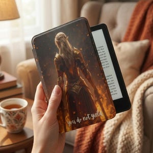 May include: A black e-reader with a cover depicting a warrior in gold, brown, and orange tones, and the text "you do not yield". The e-reader is open, showing text on the screen.