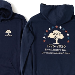 May include: A navy blue hooded sweatshirt featuring a small white tree graphic with the text 250th 1776-2026 on the front. The back displays a large white tree graphic, an arch of red, white, and blue stars, and the text 1776-2026 From Liberty’s Tree Grows Every American’s Story!