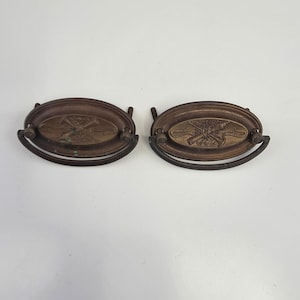 May include: A white ceramic mug with a black handle and the text "But First, Coffee" in a black, handwritten-style font. The mug is on a white surface.