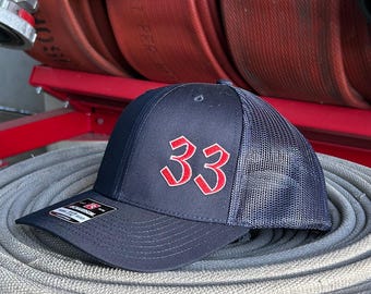 Custom embroidered Fire department hat. Navy colored richardson 112 trucker hat.