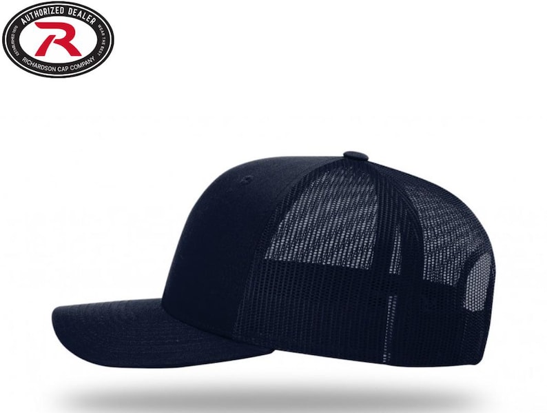 May include: A navy blue trucker hat with a curved brim and a mesh back. The hat features a structured front panel and a snapback closure. The Richardson Cap Company logo is visible on the top left.