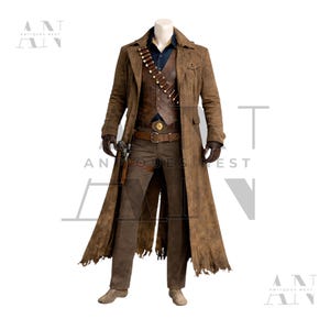 May include: A complete Western-style outfit featuring a long brown suede coat, a leather vest, and matching trousers. The ensemble includes a dark blue shirt, a belt with a decorative buckle, and a bandolier. The outfit is completed with gloves and boots.