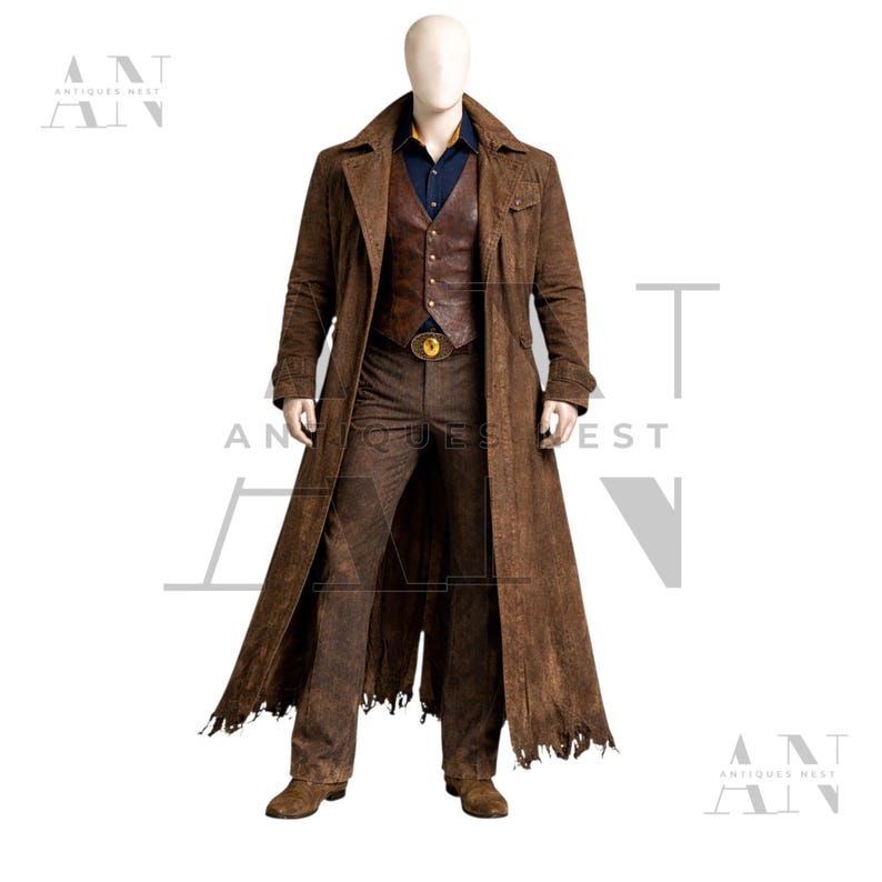 May include: A brown suede duster coat, vest, and pants ensemble. The long coat has a distressed hem. The vest is leather, and the pants are a matching brown. A gold buckle belt and a blue shirt complete the outfit. The mannequin is standing on a white background.