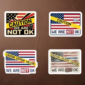 May include: Four stickers featuring the American flag design. Each sticker displays the text "CAUTION WE ARE NOT OK" with yellow caution tape. One sticker includes a fist, and another has a speech bubble with the word "help".