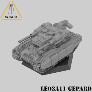 May include: A gray 3D printed model of a tank with a large turret and two cannons. The tank is labeled "LEO3A11 GEOPARD" and has the text "Maximilian Bombe" on the turret.