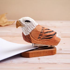 May include: A white ceramic mug with a black handle and the text "But First, Coffee" in a black, handwritten-style font. The mug is on a white surface.