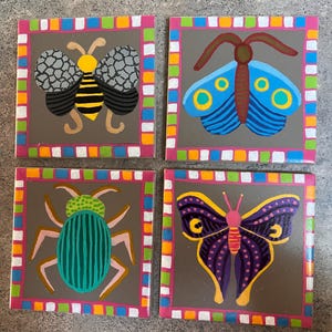 Set of four hand painted ceramic tiles
