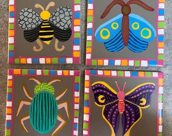 Set of four hand painted ceramic tiles