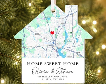 May include: A house-shaped ornament featuring a map of Providence, Rhode Island, with a red heart marker. Below the map, the text reads: HOME SWEET HOME, Olivia & Ethan, 418 MAPLEWOOD DRIVE, AUSTIN, TX 78704. It hangs from a white ribbon.