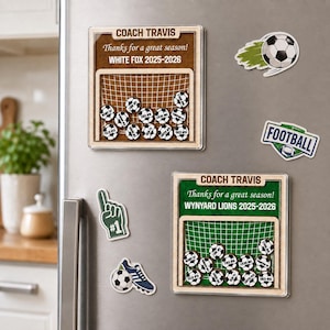 May include: Two square wooden plaques with soccer goal graphics, personalized with Coach Travis, team names, and player names on small soccer ball magnets. Includes additional magnets shaped like a soccer ball, a foam finger, and a football sign.