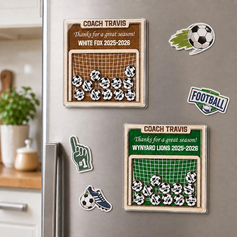 May include: Two square wooden plaques with soccer goal graphics, personalized with Coach Travis, team names, and player names on small soccer ball magnets. Includes additional magnets shaped like a soccer ball, a foam finger, and a football sign.