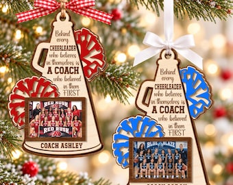 May include: Two wooden megaphone-shaped ornaments featuring red or blue pom-poms and ribbons. Each displays the text "Behind every CHEERLEADER who believes in themselves is A COACH who believed in them FIRST" and a photo of a cheer team.